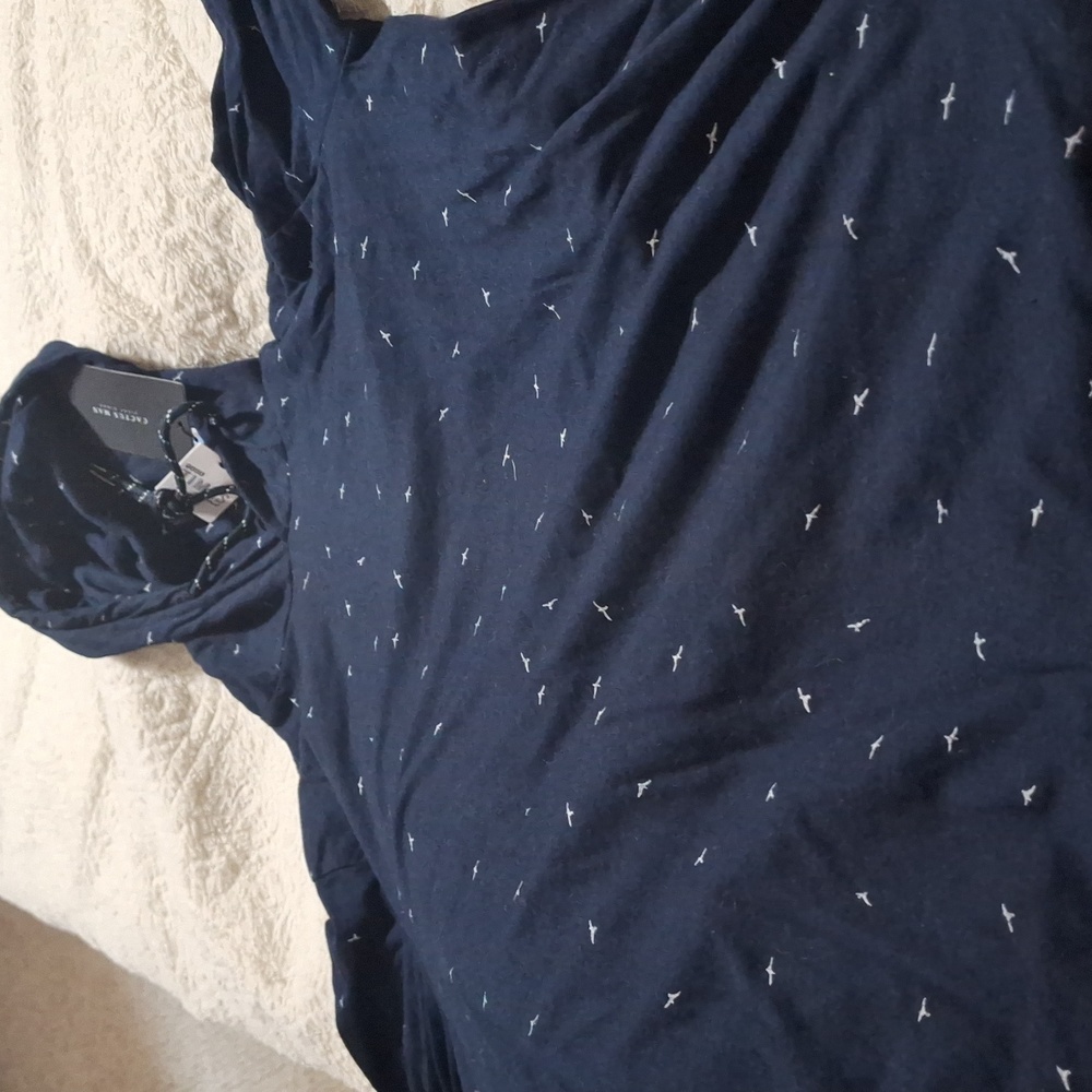 A long sleeved shirt with hood Dark blue with white bird all over new with tags